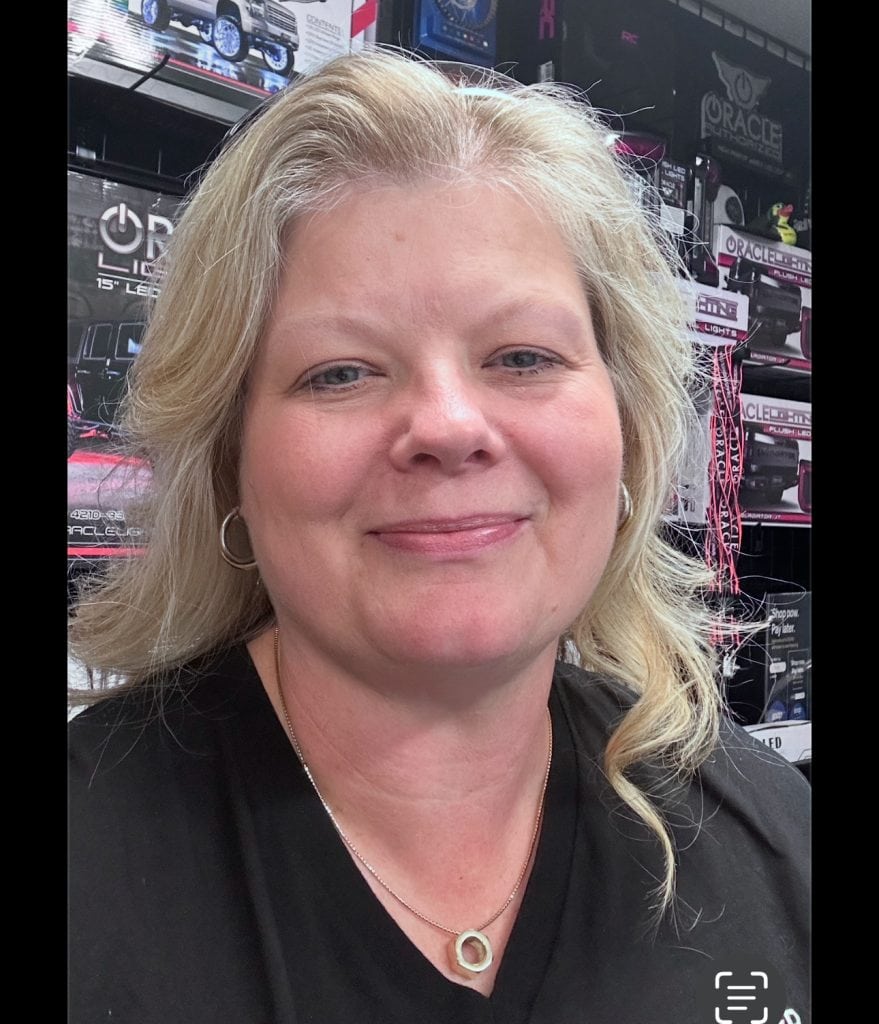 Happy woman smiling at Asheville Area Business Association event, showcasing local business networking.